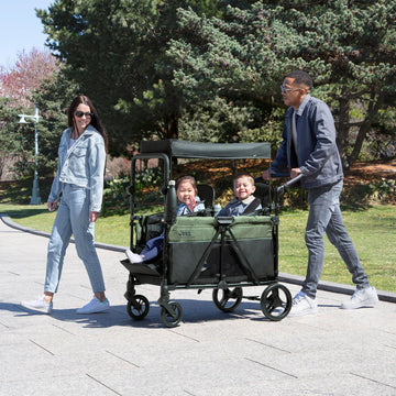 Delta Children - Jeep Wrangler Deluxe 4 Seater Stroller Wagon - enhanced Quad Stroller Wagon for 4 Kids with Convertible Seats Adjustable Push/Pull Handles Removable Canopy & Flat Fold Black/Green