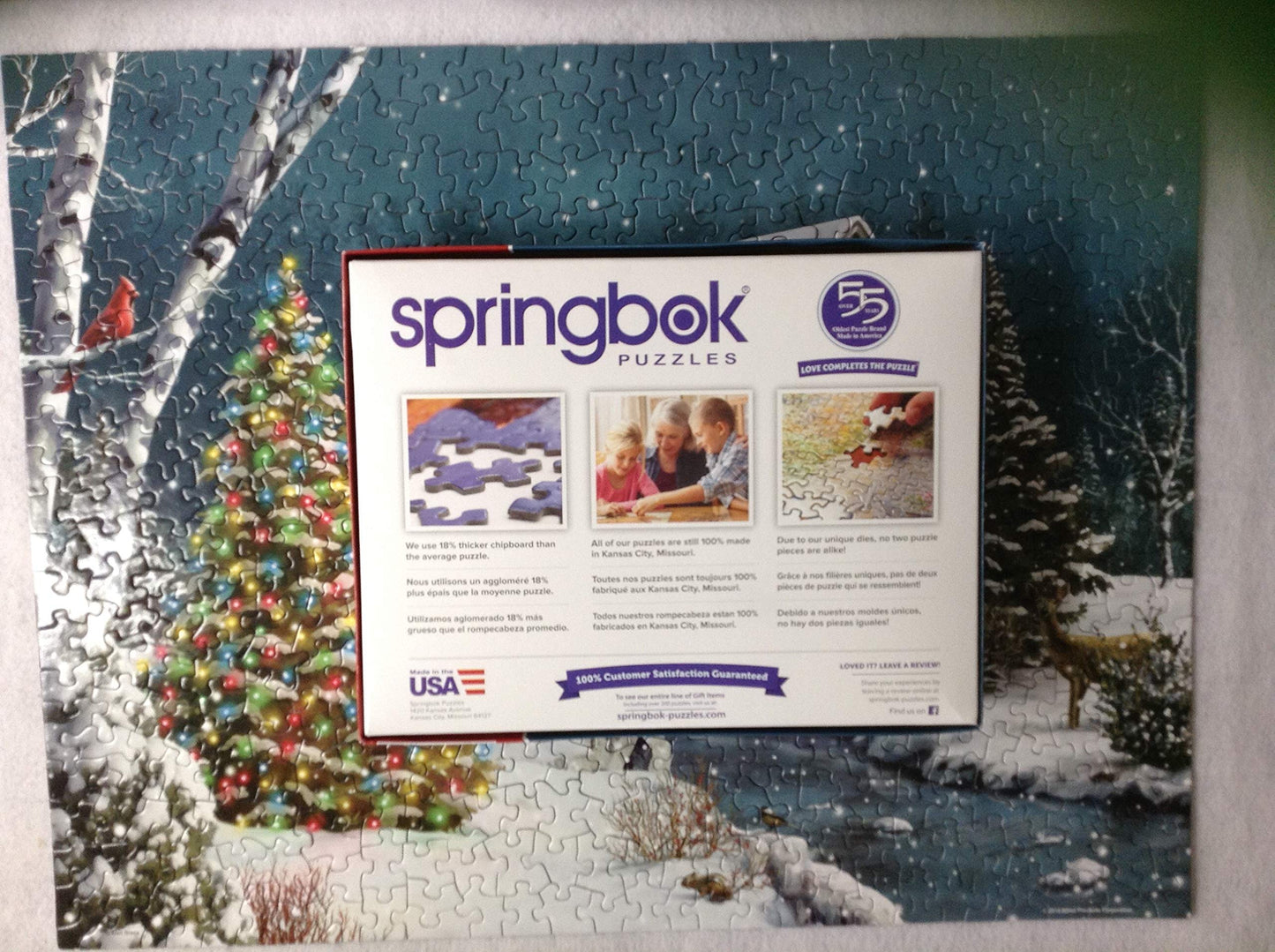 Springbok The Falling Snow 500 Piece Jigsaw Puzzle For Adults Features A Holiday Cabin Glowing In The Snow With A Decorated Christmas Tree Beside It