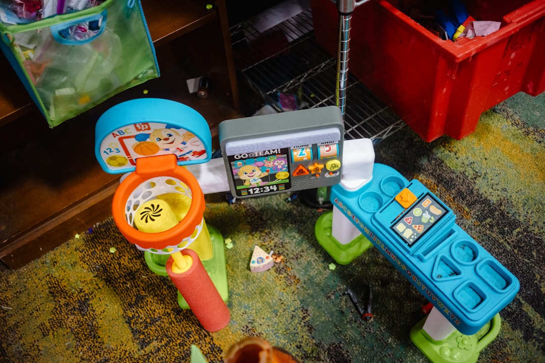 Colorful kids pretend play grocery checkout counter toy set with scanner, display screen and play accessories on classroom carpet.