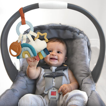 Itzy Ritzy Teething Activity Toy - Bitzy Busy Ring Infant Teething Toy Features Braided Ring & Dangling Toys, Includes Teether, Textured Ribbons, Crinkle Sound & Jingle Bell - 0 Months & Up (Rainbow)