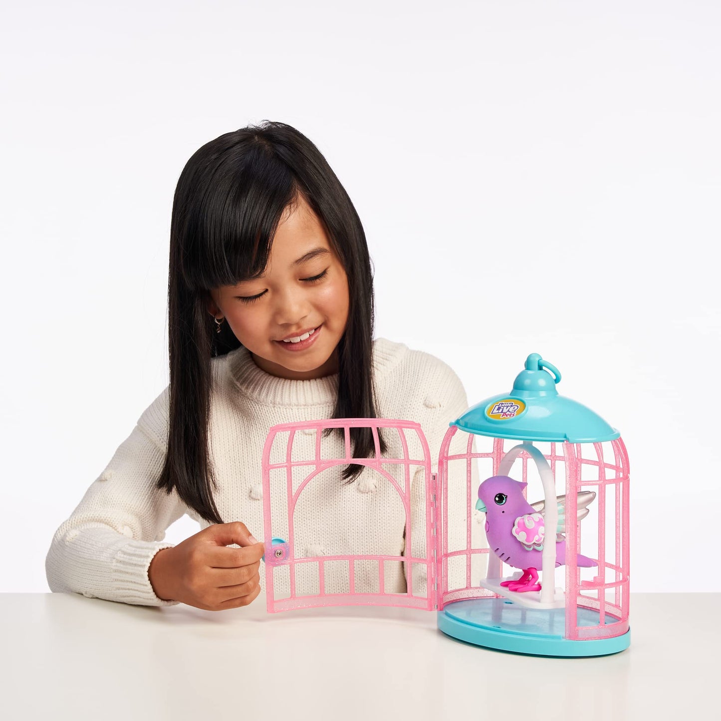 Little Live Pets - Lil Bird & Bird Cage: Polly Pearl, New Light Up Wings with 20 + Sounds, and Reacts to Touch