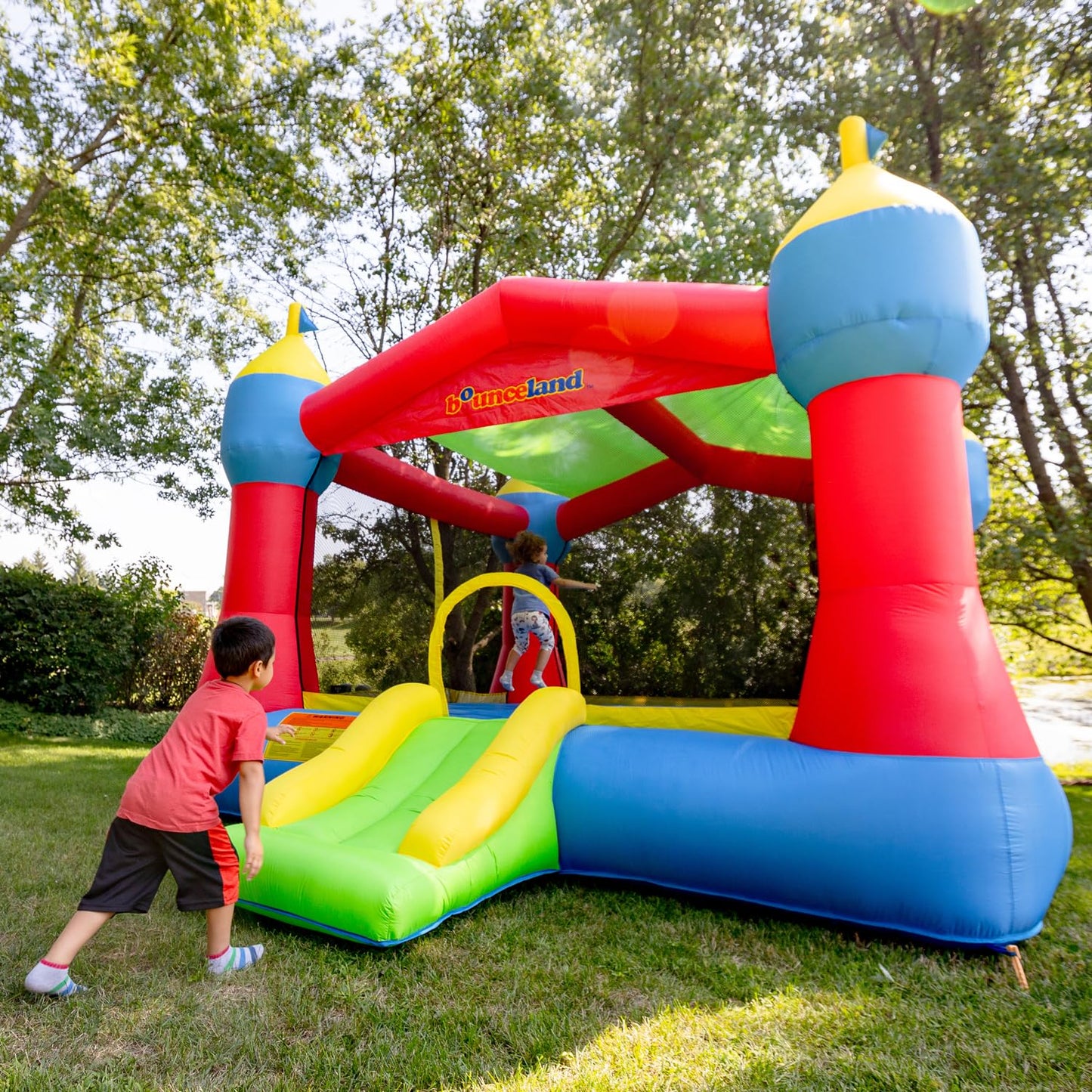Bounceland Inflatable Party Castle Bounce House Bouncer, 16 ft L x 13 ft W x 10.3 ft H, Basketball Hoop, Removable Sun Roof, UL