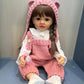 TERABITHIA 22 Inches Long Brown Hair Silicone Vinyl Full Body Anatomically Correct Lifelike Reborn Baby Doll Realistic Newborn Toddler Girl Dolls in Pink Woolen Set