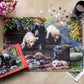 Crown Point Graphics Cozy Moments - 1000 Piece Jigsaw Puzzle - Artist Kevin Daniel - Soft Touch Design - Black Labrador Dog Puzzle With Yellow, Black And Chocolate Lab Puppies