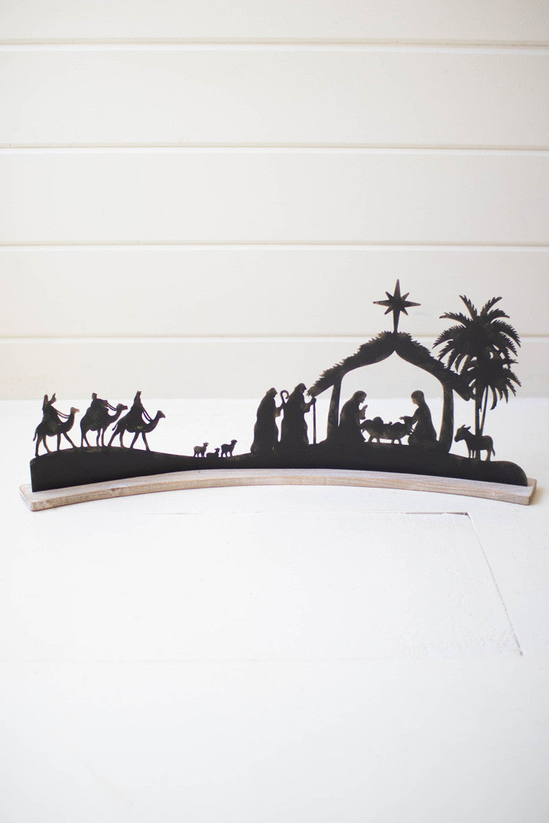 BLACK METAL NATIVITY ON A CURVED WHITE WOOD BASE