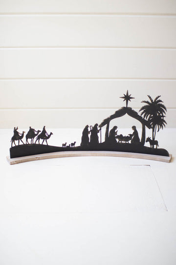 BLACK METAL NATIVITY ON A CURVED WHITE WOOD BASE