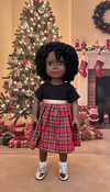 A Dark Brown Skin Tone Doll in a Black & Red Holiday Dress