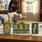 Graduation party tabletop decor set: wooden blocks in green and gold, glittered letter blocks with 'Congrats' banner and tie tr