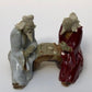 Ceramic FigurineTwo Men Sitting On A BenchColor: White & Red